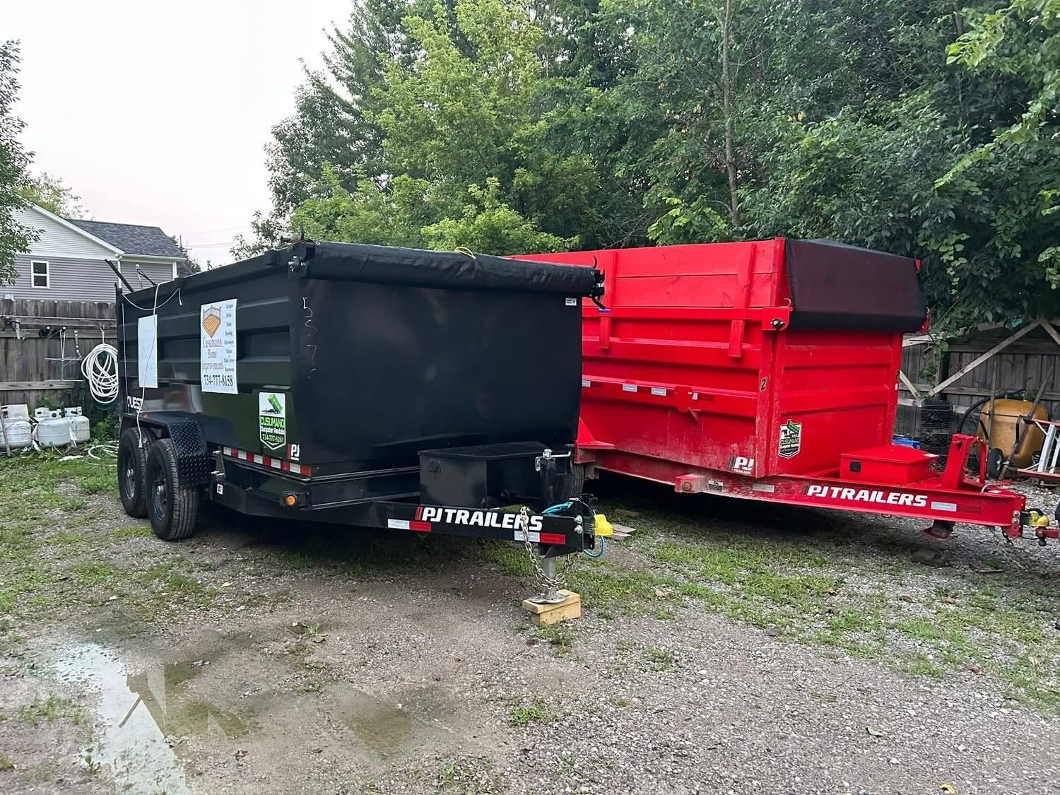 Black and red Cusumano dump trailers parked side by side